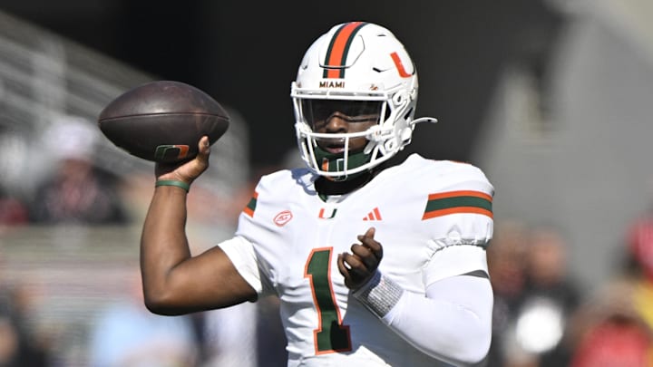 Oct 19, 2024; Louisville, Kentucky, USA; Miami Hurricanes quarterback Cam Ward (1) looks to pass against the Louisville Cardinals during the first quarter at L&N Federal Credit Union Stadium. Mandatory Credit: Jamie Rhodes-Imagn Images