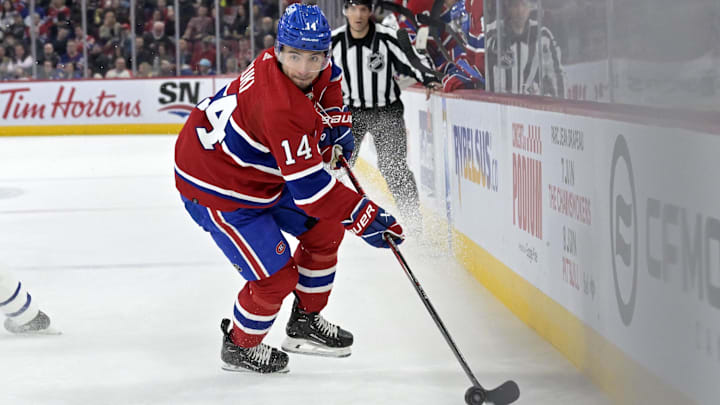 Apr 6, 2024; Montreal, Quebec, CAN; Montreal Canadiens forward Nick Suzuki (14) plays the puck during the third period of the game against the Toronto Maple Leafs at the Bell Centre. Mandatory Credit: Eric Bolte-Imagn Images