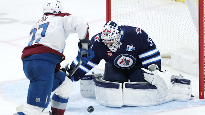 Mar 26, 2026; Winnipeg, Manitoba, CAN; Colorado Avalanche defenseman Brett Kulak (27) shoots on Winnipeg Jets goaltender Connor Hellebuyck (37) in the third period at Canada Life Centre. Mandatory Credit: James Carey Lauder-Imagn Images Mar 26, 2026; Winnipeg, Manitoba, CAN; Colorado Avalanche defenseman Brett Kulak (27) shoots on Winnipeg Jets goaltender Connor Hellebuyck (37) in the third period at Canada Life Centre. Mandatory Credit: James Carey Lauder-Imagn Images