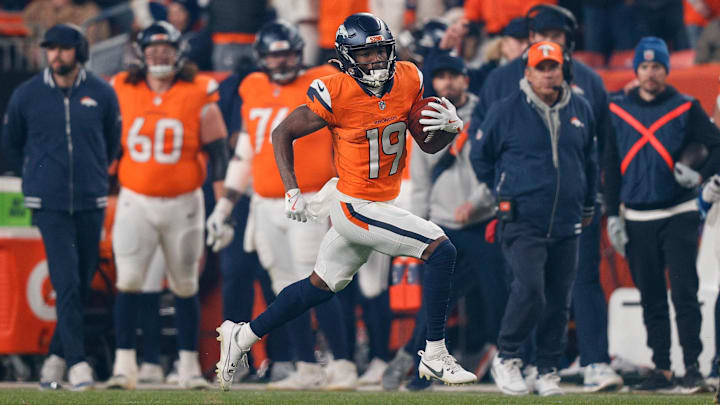 Dec 15, 2024; Denver, Colorado, USA; Denver Broncos wide receiver Marvin Mims Jr. (19) runs the ball on a punt reception in the fourth quarter against the Indianapolis Colts at Empower Field at Mile High. 