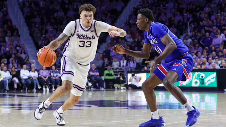 Feb 8, 2025; Manhattan, Kansas, USA; Kansas State Wildcats forward Coleman Hawkins (33) drives to the basket against Kansas Jayhawks forward Flory Bidunga (40) during the first half at Bramlage Coliseum. Mandatory Credit: Scott Sewell-Imagn Images