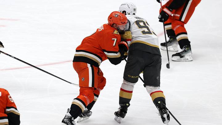 Feb 1, 2026; Anaheim, California, USA;  Anaheim Ducks defenseman Radko Gudas (7) checks Vegas Golden Knights right wing Mitch Marner (93) during the third period at Honda Center. Mandatory Credit: Kiyoshi Mio-Imagn Images