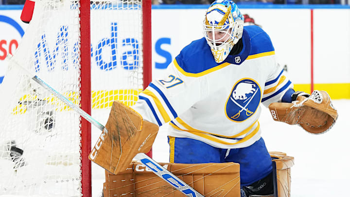 Dec 15, 2024; Toronto, Ontario, CAN; Buffalo Sabres goaltender Devon Levi (27) steers the puck to the side of the net against the Toronto Maple Leafs during the first period at Scotiabank Arena. Mandatory Credit: Nick Turchiaro-Imagn Images