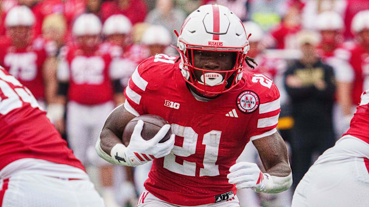 Oct 25, 2025; Lincoln, Nebraska, USA; Nebraska Cornhuskers running back Emmett Johnson (21) runs the ball against the Northwestern Wildcats during the first quarter at Memorial Stadium. 