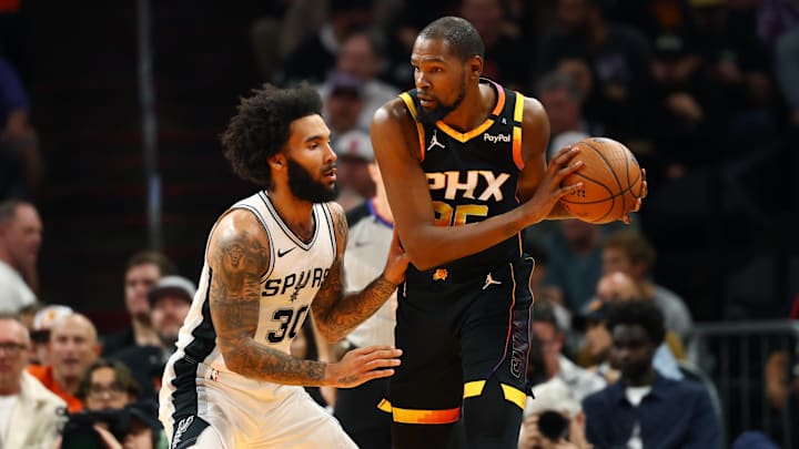 Dec 3, 2024; Phoenix, Arizona, USA; San Antonio Spurs forward Julian Champagnie (30) against Phoenix Suns forward Kevin Durant (35) during an NBA Cup game at Footprint Center. Mandatory Credit: Mark J. Rebilas-Imagn Images