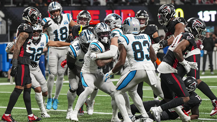 Jan 5, 2025; Atlanta, Georgia, USA; Carolina Panthers running back Miles Sanders (6) scores the game winning touchdown against the Atlanta Falcons in overtime at Mercedes-Benz Stadium. Mandatory Credit: Dale Zanine-Imagn Images
