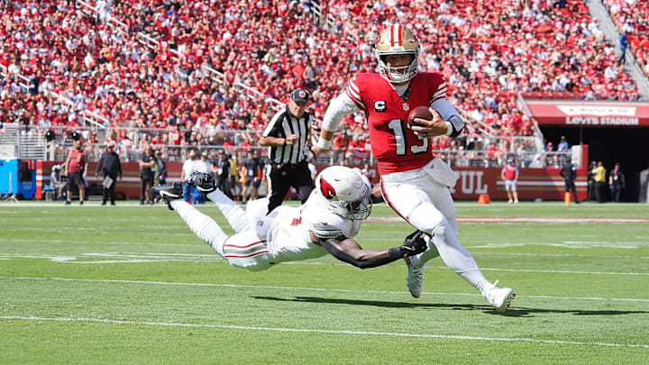 Oct 6, 2024; Santa Clara, California, USA; San Francisco 49ers quarterback Brock Purdy (13) carries the ball against Arizona Cardinals linebacker Krys Barnes (51) during the first quarter at Levi's Stadium. Mandatory Credit: Kelley L Cox-Imagn Images Oct 6, 2024; Santa Clara, California, USA; San Francisco 49ers quarterback Brock Purdy (13) carries the ball against Arizona Cardinals linebacker Krys Barnes (51) during the first quarter at Levi's Stadium. Mandatory Credit: Kelley L Cox-Imagn Images