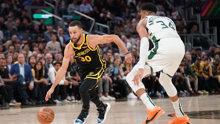 Mar 6, 2024; San Francisco, California, USA; Golden State Warriors guard Stephen Curry (30) dribbles past Milwaukee Bucks forward Giannis Antetokounmpo (34) in the third quarter at the Chase Center. Mandatory Credit: Cary Edmondson-Imagn Images