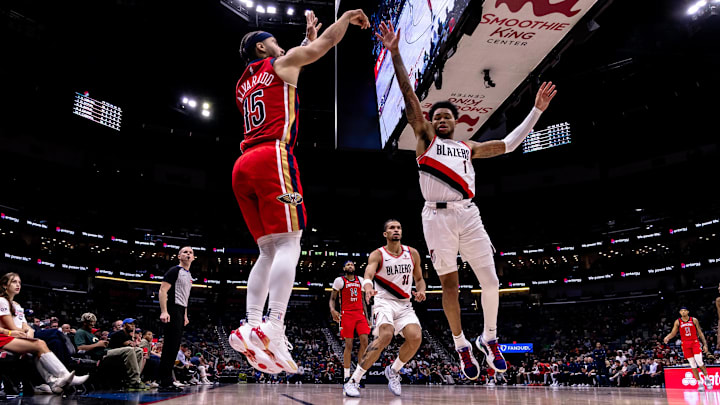 Nov 4, 2024; New Orleans, Louisiana, USA;  New Orleans Pelicans guard Jose Alvarado (15) shoots a three point basket against Portland Trail Blazers guard Anfernee Simons (1) during the second half at Smoothie King Center. Mandatory Credit: Stephen Lew-Imagn Images