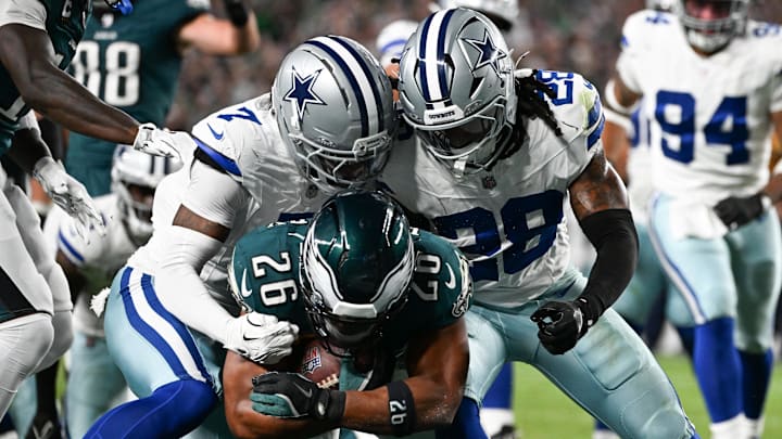Eagles RB Saquon Barkley carries the ball for a touchdown defended by Dallas Cowboys CB Trevon Diggs and S Malik Hooker.