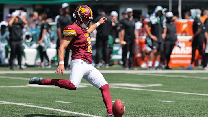 Aug 10, 2024; East Rutherford, New Jersey, USA; Washington Commanders place kicker Riley Patterson (15) kicks off during the fourth quarter against the New York Jets at MetLife Stadium.