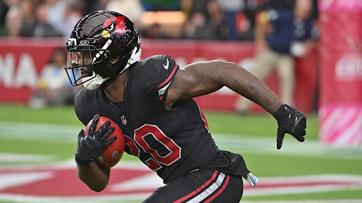 Oct 5, 2025; Glendale, Arizona, USA; Arizona Cardinals running back Bam Knight (20) returns a kickoff against the Tennessee Titans during the fourth quarter at State Farm Stadium. 