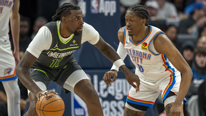 Feb 23, 2025; Minneapolis, Minnesota, USA; Minnesota Timberwolves center Naz Reid (11) dribbles the ball as Oklahoma City Thunder forward Jalen Williams (8) plays defense in the first half at Target Center. Mandatory Credit: Jesse Johnson-Imagn Images