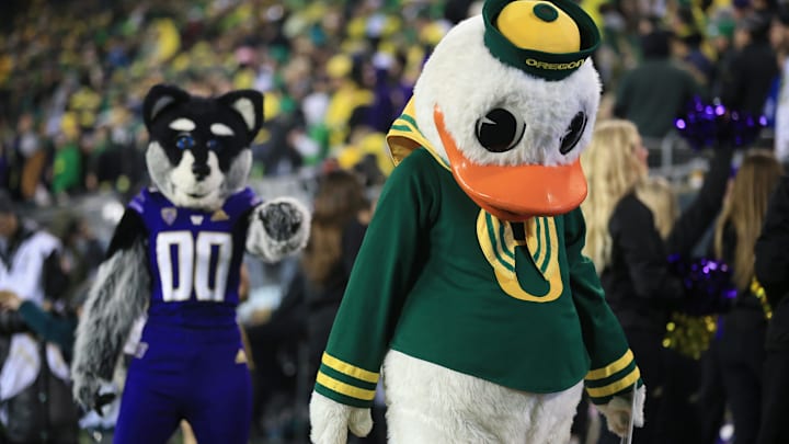 The Huskies and Ducks mascot interact during the 2022 game in Eugene, won by the UW 37-34. 