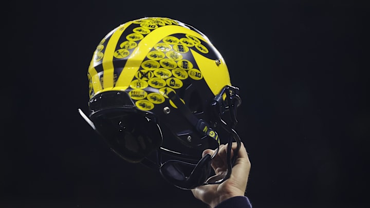 Dec 3, 2022; Indianapolis, Indiana, USA; A Michigan Wolverines player holds their helmet following their 43-22 victory against Purdue in the Big Ten Championship at Lucas Oil Stadium. Mandatory Credit: Trevor Ruszkowski-Imagn Images