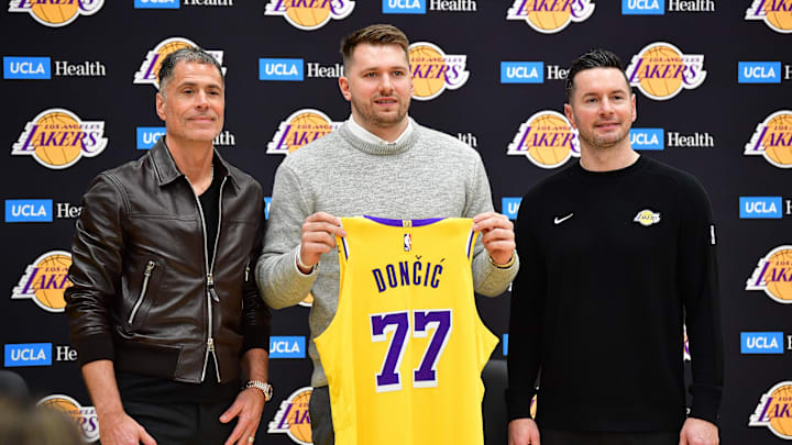 Feb 4, 2025; El Segundo, CA, USA; Los Angeles Lakers guard Luka Doncic poses for photos with general manager Rob Pelinka and head coach JJ Redick at UCLA Health Training Center. Mandatory Credit: Gary A. Vasquez-Imagn Images