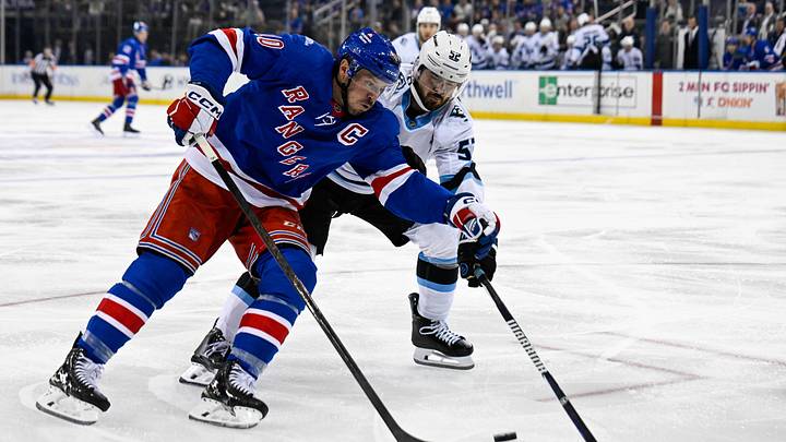 Oct 4, 2026; New York, New York, USA;  Utah Mammoth defenseman MacKenzie Weegar (52) defends against New York Rangers center J.T. Miller (10) during the second period at Madison Square Garden.  Mandatory Credit: Dennis Schneidler-Imagn Images