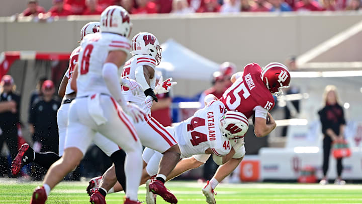 Nov 15, 2025; Bloomington, Indiana, USA; Indiana Hoosiers quarterback Fernando Mendoza (15) is sacked by Wisconsin Badgers linebacker Cooper Catalano (44) during the second half at Memorial Stadium. Nov 15, 2025; Bloomington, Indiana, USA; Indiana Hoosiers quarterback Fernando Mendoza (15) is sacked by Wisconsin Badgers linebacker Cooper Catalano (44) during the second half at Memorial Stadium.
