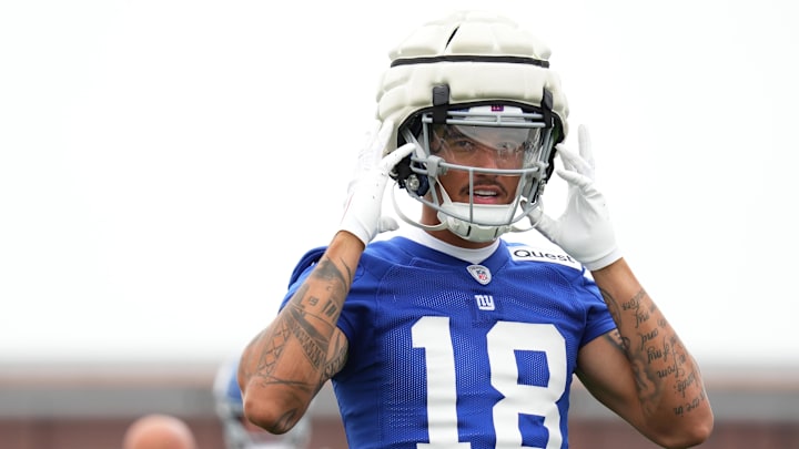 Jul 25, 2024; East Rutherford, NY, USA; New York Giants wide receiver Isaiah Hodgins (18) fastens his helmet during training camp at Quest Diagnostics Training Center. Mandatory Credit: Lucas Boland-Imagn Images