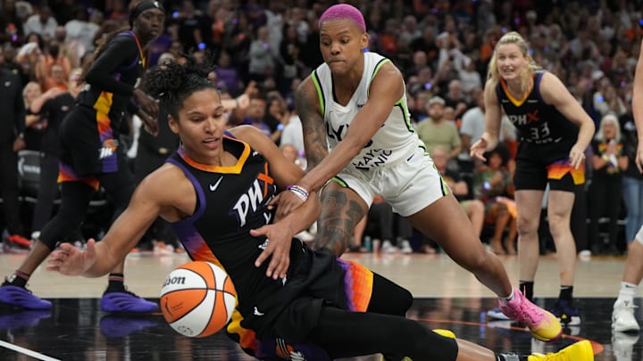 Sep 26, 2025; Phoenix, Arizona, USA; Minnesota Lynx guard Courtney Williams (10) and Phoenix Mercury forward Alyssa Thomas (25) battle for the loose ball during game three of the second round for the 2025 WNBA Playoffs at PHX Arena. Mandatory Credit: Rick Scuteri-Imagn Images