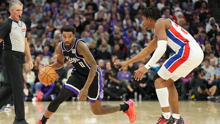 Sacramento Kings guard Malik Monk (0) controls the ball against Detroit Pistons guard Jaden Ivey (23)