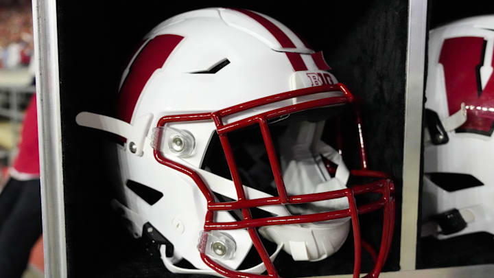 Aug 28, 2025; Madison, Wisconsin, USA;  General view of a Wisconsin Badgers football helmet on the sidelines during the game against the Miami (OH) RedHawks at Camp Randall Stadium.