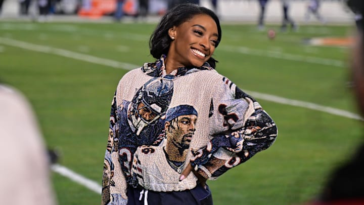 Simone Biles poses for a photo on the sidelines before the game between the Chicago Bears and the Seattle Seahawks at Soldier Field. 