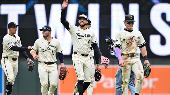 Apr 27, 2025; Minneapolis, Minnesota, USA; Minnesota Twins shortstop Carlos Correa (4) reacts to the crowd with outfielder Harrison Bader (12) and teammates after the game against the Los Angeles Angels at Target Field.