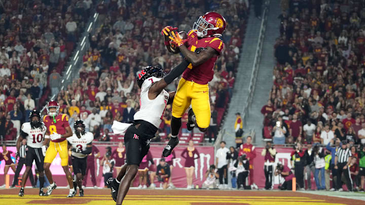 Oct 25, 2024; Los Angeles, California, USA; Southern California Trojans wide receiver Zachariah Branch (1) attempts to catch the ball against Rutgers Scarlet Knights defensive back Robert Longerbeam (7) in the first half at United Airlines Field at Los Angeles Memorial Coliseum. Mandatory Credit: Kirby Lee-Imagn Images