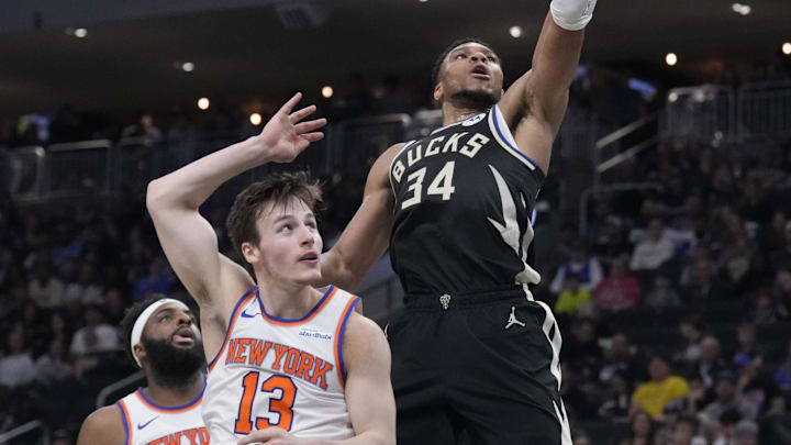 Mar 28, 2025; Milwaukee, Wisconsin, USA;  Milwaukee Bucks forward Giannis Antetokounmpo (34) drives to the basket against New York Knicks guard Tyler Kolek (13) in the first half at Fiserv Forum. Mandatory Credit: Michael McLoone-Imagn Images