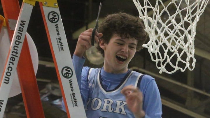 York's Alex Taylor is all smiles after cutting down a piece of the net following Friday's 50-40 win over Medomak Valley in the Class B South championship game at The Expo in Portland, Maine.