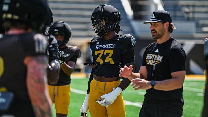 Avery Sledge (#33) with Coach Joe Bolden going over last-minute adjustments before the scrimmage at The Rock. Avery Sledge (#33) with Coach Joe Bolden going over last-minute adjustments before the scrimmage at The Rock.