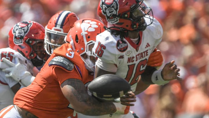 Clemson Tigers defensive end T.J. Parker hits North Carolina State Wolfpack quarterback CJ Bailey to force a fumble during the first quarter at Memorial Stadium. Clemson Tigers defensive end T.J. Parker hits North Carolina State Wolfpack quarterback CJ Bailey to force a fumble during the first quarter at Memorial Stadium.