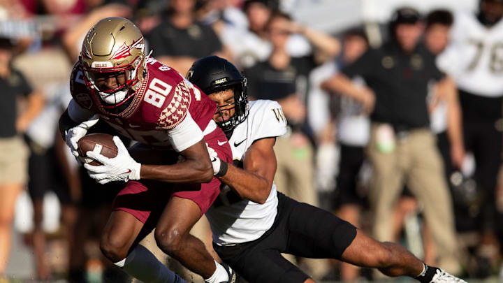 Florida State Seminoles wide receiver Ontaria Wilson (80) is tackled by a defender. The Florida State Seminoles lost to the Wake Forest Demon Deacons 31-21 Saturday, Oct. 1, 2022.

Fsu V Wake Forest Second805