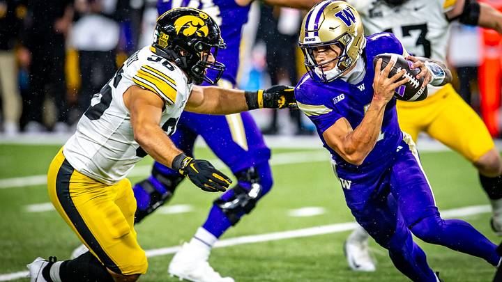 UW quarterback Demond Williams Jr. encounters Iowa linebacker Jayden Montgomery. UW quarterback Demond Williams Jr. encounters Iowa linebacker Jayden Montgomery.