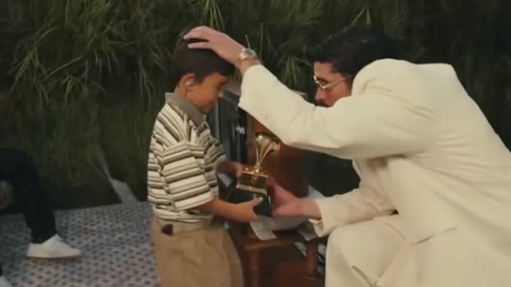 Bad Bunny hands his Grammy to a young boy during Super Bowl LX halftime show.