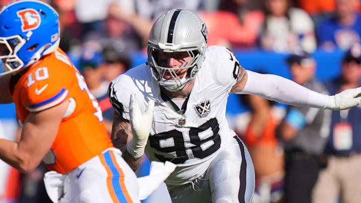 Oct 6, 2024; Denver, Colorado, USA; Las Vegas Raiders defensive end Maxx Crosby (98) chases down Denver Broncos quarterback Bo Nix (10) for a sack in the second half at Empower Field at Mile High. Mandatory Credit: Ron Chenoy-Imagn Images