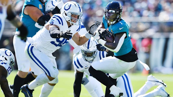 Indianapolis Colts defensive tackle Taven Bryan (96) and teammates try to stop Jacksonville Jaguars running back Travis Etienne Jr. (1) during first quarter action. The Jacksonville Jaguars hosted the Indianapolis Colts at EverBank Stadium in Jacksonville, FL Sunday, October 15, 2023. The Jaguars ended the first half with a 21 to 6 lead. [Bob Self/Florida Times-Union]
