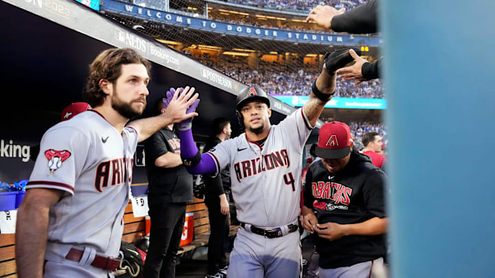 Arizona Diamondbacks starting pitcher Zac Gallen (23) high-fives Ketel Marte (4) after scoring against the Los Angeles Dodgers in the first inning during Game 2 of the NLDS at Dodger Stadium in Los Angeles on Oct. 9, 2023. Arizona Diamondbacks starting pitcher Zac Gallen (23) high-fives Ketel Marte (4) after scoring against the Los Angeles Dodgers in the first inning during Game 2 of the NLDS at Dodger Stadium in Los Angeles on Oct. 9, 2023.