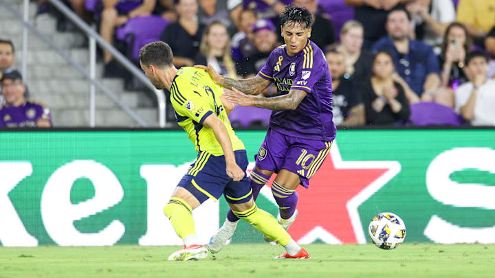 Aug 31, 2024; Orlando, Florida, USA; Orlando City midfielder Facundo Torres (10) controls the ball from Nashville SC defender Daniel Lovitz (2) in the second half at Inter&Co Stadium. Mandatory Credit: Nathan Ray Seebeck-USA TODAY Sports