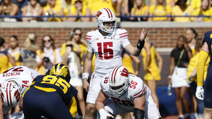 Oct 4, 2025; Ann Arbor, Michigan, USA;  Wisconsin Badgers quarterback Hunter Simmons (15) gets set to run a play in the first half against the Michigan Wolverines at Michigan Stadium.