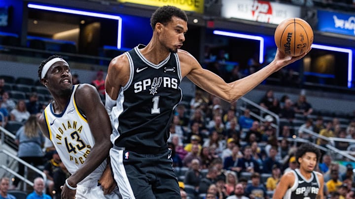 Oct 13, 2025; Indianapolis, Indiana, USA; San Antonio Spurs forward/center Victor Wembanyama (1) rebounds the ball while Indiana Pacers forward Pascal Siakam (43) defends in the first half at Gainbridge Fieldhouse. Mandatory Credit: Trevor Ruszkowski-Imagn Images