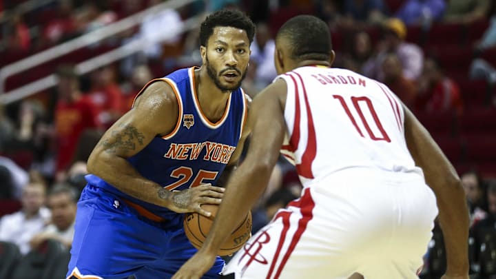 Oct 4, 2016; Houston, TX, USA; New York Knicks guard Derrick Rose (25) controls the ball as Houston Rockets guard Eric Gordon (10) defends during the third quarter at Toyota Center. The Rockets won 130-103. Mandatory Credit: Troy Taormina-Imagn Images