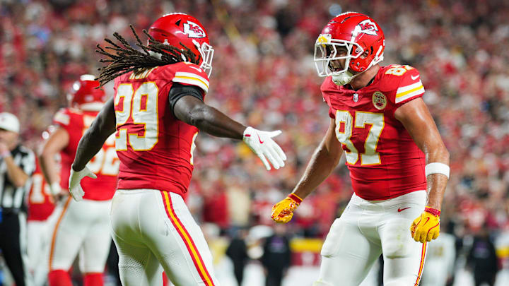 Oct 7, 2024; Kansas City, Missouri, USA; Kansas City Chiefs running back Kareem Hunt (29) celebrates with tight end Travis Kelce (87) after scoring a touchdown during the first half against the New Orleans Saints at GEHA Field at Arrowhead Stadium. Mandatory Credit: Jay Biggerstaff-Imagn Images