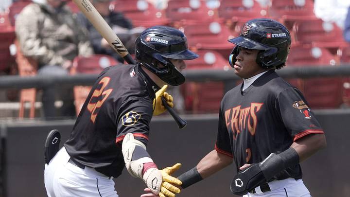 Wisconsin Timber Rattlers Tayden Hall (22) congratulates Braylon Payne (6) after he scored a run against the South Bend Cubs during their baseball game Wednesday, May 13, 2026, at Neuroscience Group Field at Fox Cities Stadium in Grand Chute, Wisconsin. The Timber Rattlers won 11-6.