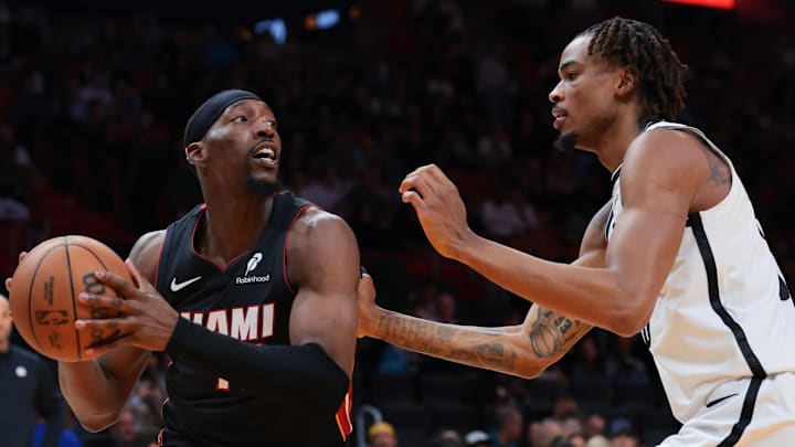 Mar 3, 2026; Miami, Florida, USA; Miami Heat center Bam Adebayo (13) protects the basketball from Brooklyn Nets center Nic Claxton (33) during the third quarter at Kaseya Center. Mandatory Credit: Sam Navarro-Imagn Images
