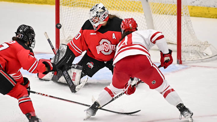 Ohio State Buckeyes goaltender Amanda Thiele deflects a shot by Wisconsin Badgers defender Vivian Jungels during the second period in a game Thursday, January 2, 2025, at LaBahn Arena in Madison, Wisconsin.