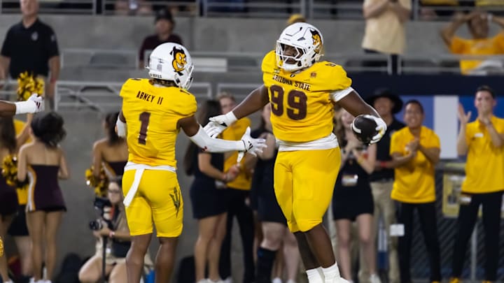 Sep 7, 2024; Tempe, Arizona, USA; Arizona State Sun Devils defensive lineman C.J. Fite (99) celebrates with defensive back Keith Abney II (1) after recovering a fumble for a touchdown against the Mississippi State Bulldogs in the first half at Mountain America Stadium. Mandatory Credit: Mark J. Rebilas-Imagn Images Sep 7, 2024; Tempe, Arizona, USA; Arizona State Sun Devils defensive lineman C.J. Fite (99) celebrates with defensive back Keith Abney II (1) after recovering a fumble for a touchdown against the Mississippi State Bulldogs in the first half at Mountain America Stadium. Mandatory Credit: Mark J. Rebilas-Imagn Images