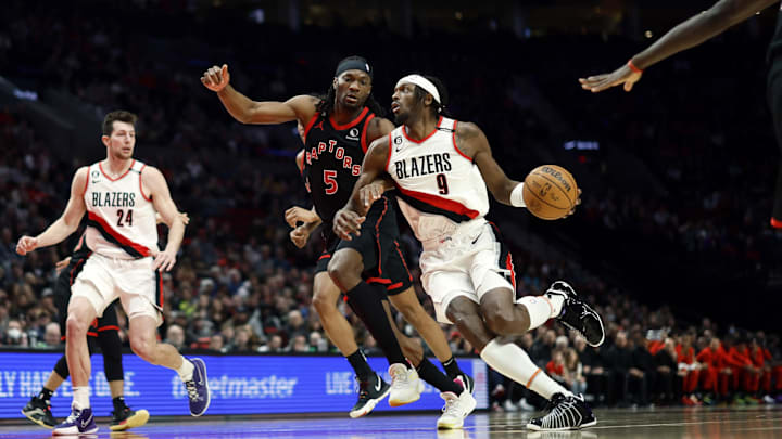 Jan 28, 2023; Portland, Oregon, USA; Portland Trail Blazers small forward Jerami Grant (9) drives to the basket against Toronto Raptors power forward Precious Achiuwa (5) during the first half at Moda Center. Mandatory Credit: Soobum Im-Imagn Images