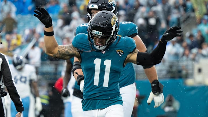 Dec 29, 2024; Jacksonville, Florida, USA;  Jacksonville Jaguars wide receiver Parker Washington (11) celebrates his touchdown against the Tennessee Titans in the second quarter at EverBank Stadium. Mandatory Credit: Jeremy Reper-Imagn Images